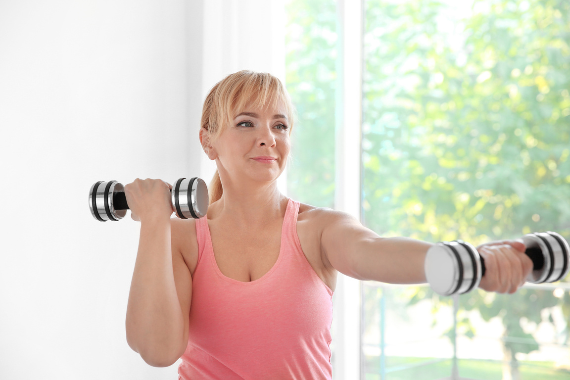 Middle Age Woman Exercising with Dumbbells